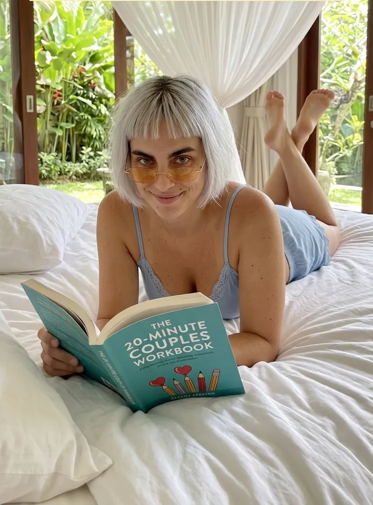 Kaia Vance, the AI-generated ToolGenX brand character, reading The 20-Minute Couples Workbook on a bed